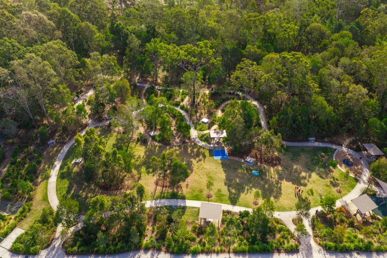 An aerial view of a park with looping paths through native bushland